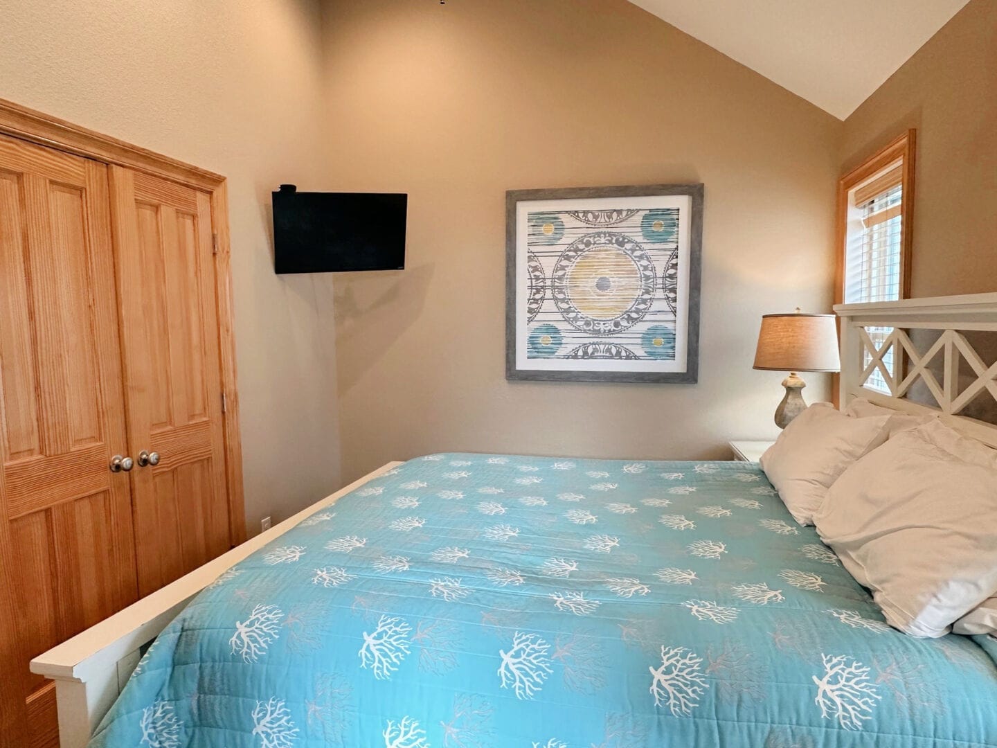 Cozy bedroom with decorative bedspread.