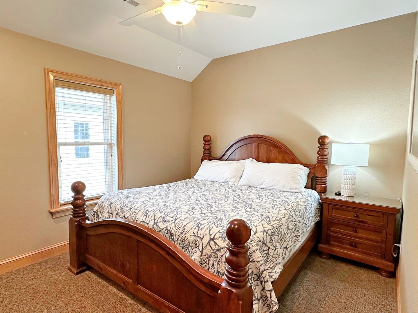 Bedroom with wooden bed and lamp.