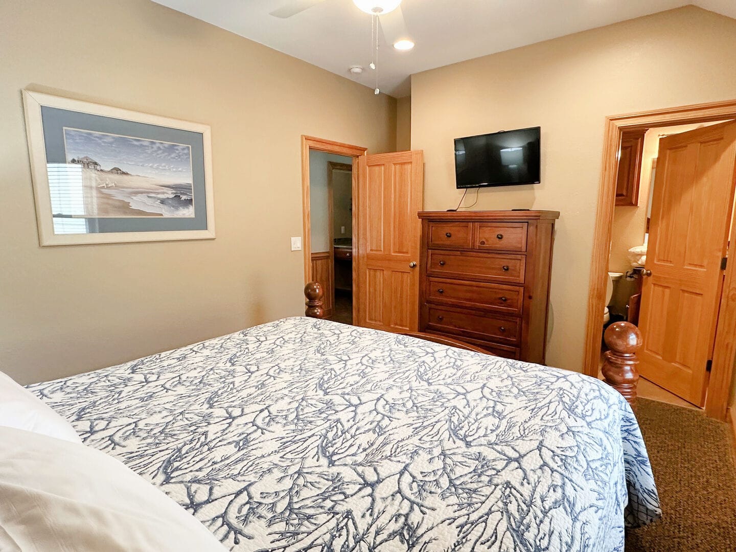 Cozy bedroom with dresser, TV.