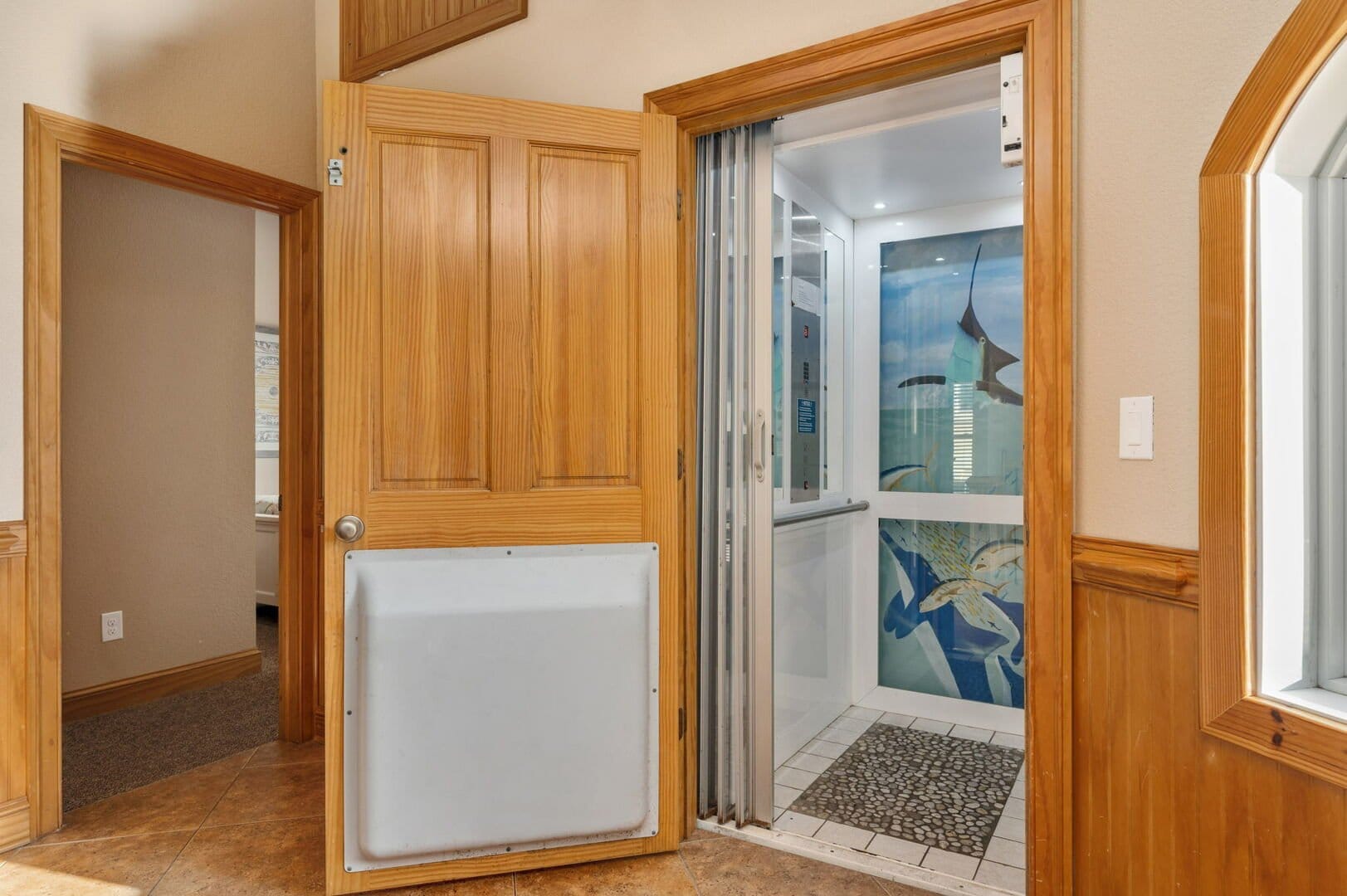 Residential elevator with wooden door.