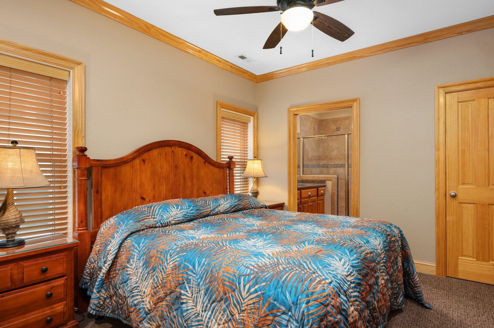 Bedroom with colorful bedding.