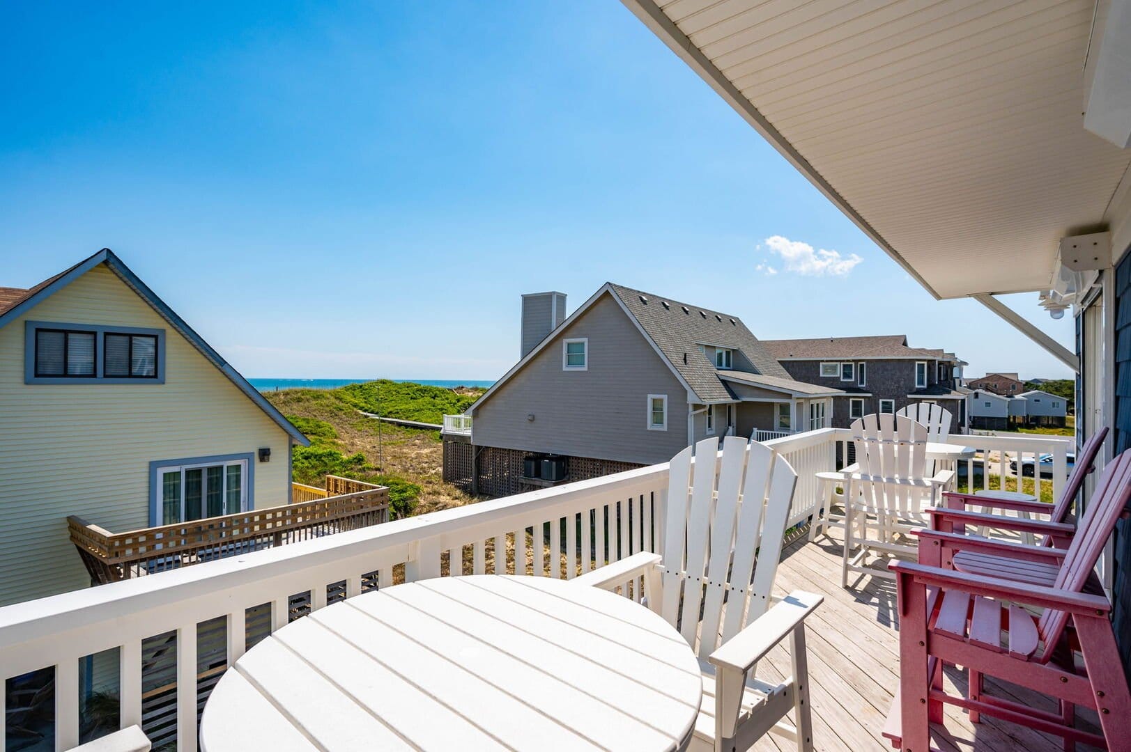 Deck overlooking ocean and houses.