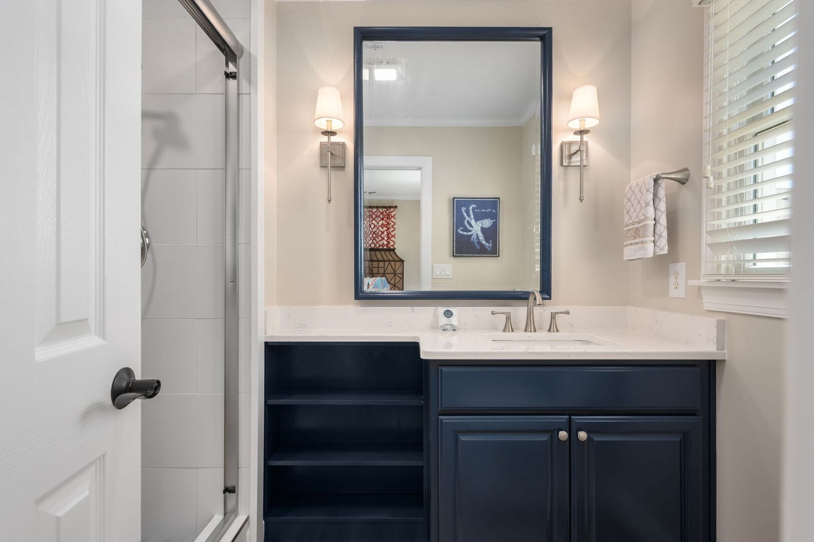 Modern bathroom with navy vanity.
