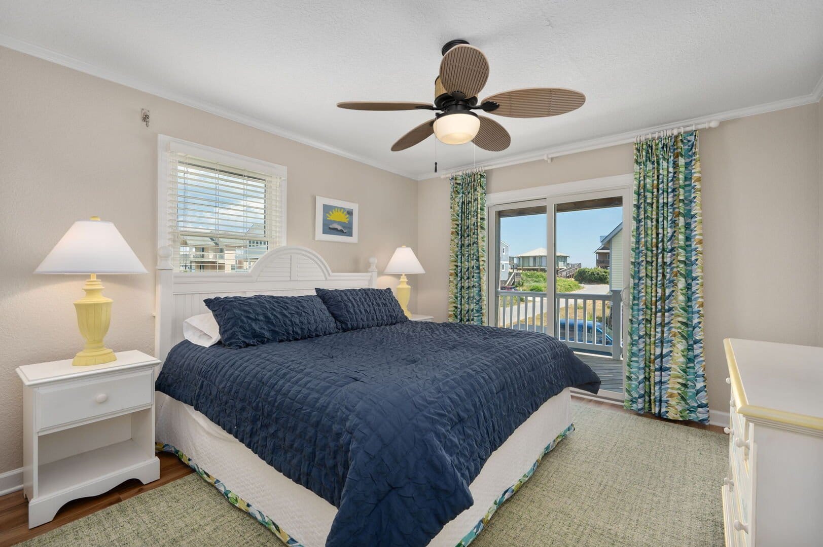 Bedroom with blue bedding, window view.