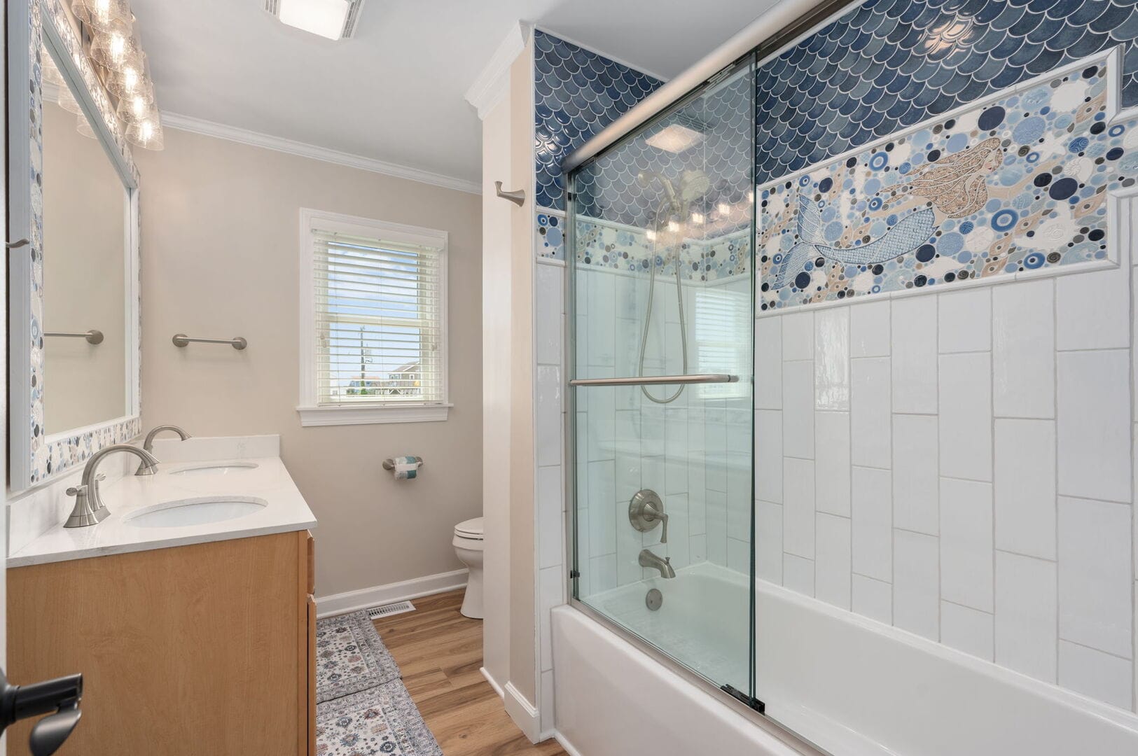 Bathroom with ornate shower tiles.