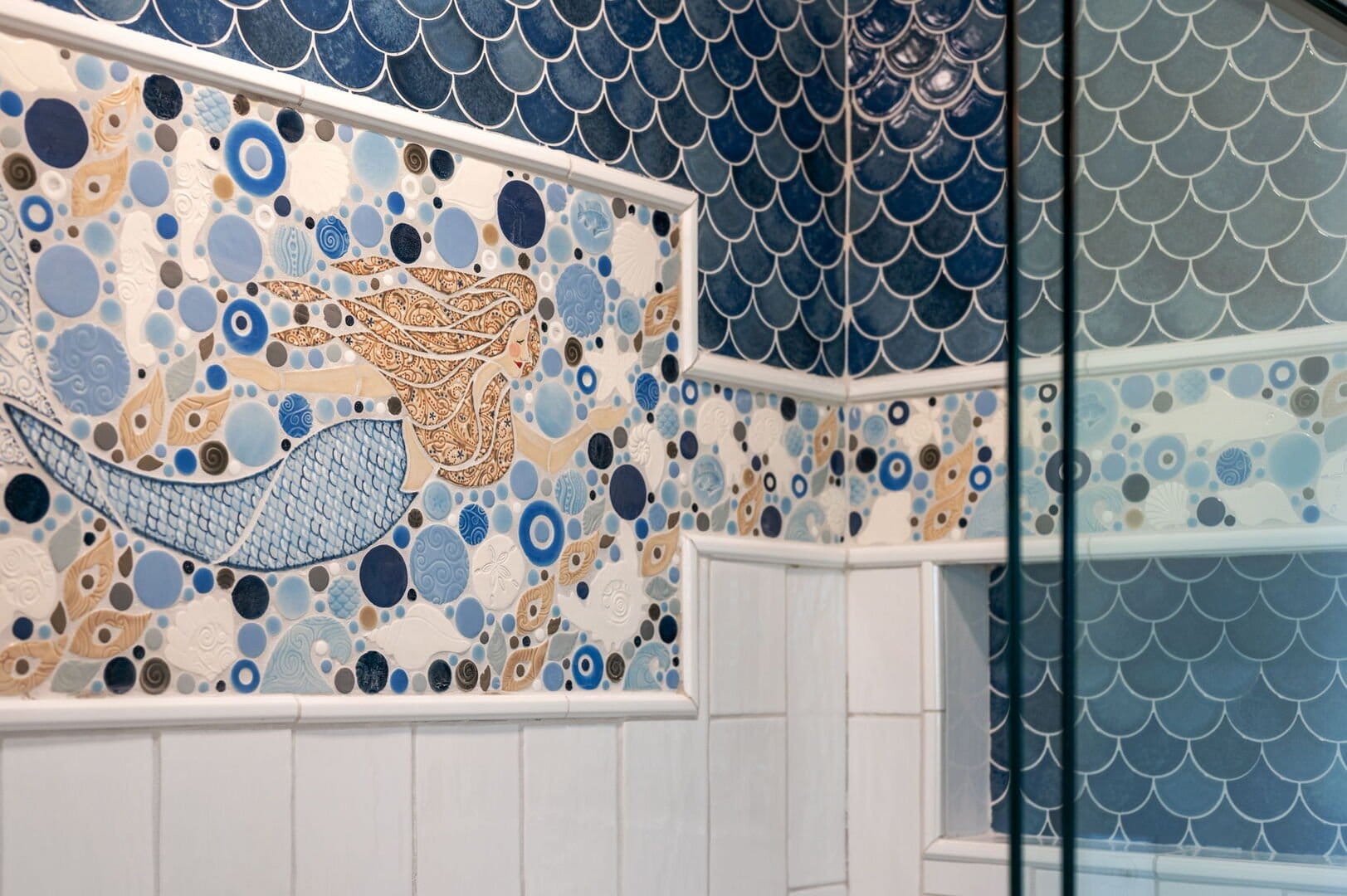 Mermaid mosaic on bathroom tiles.