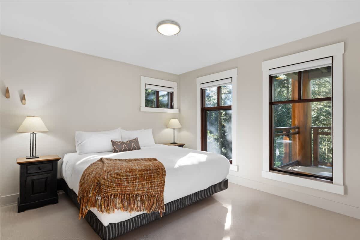 Bright bedroom with large windows.