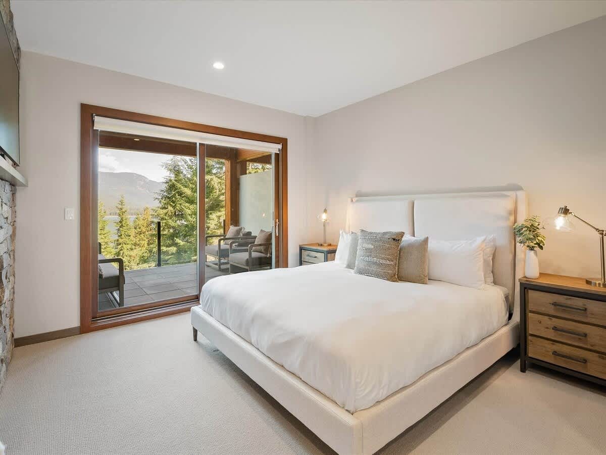 Bright bedroom with mountain view balcony.