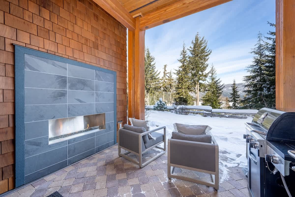 Outdoor patio with fireplace, snow.