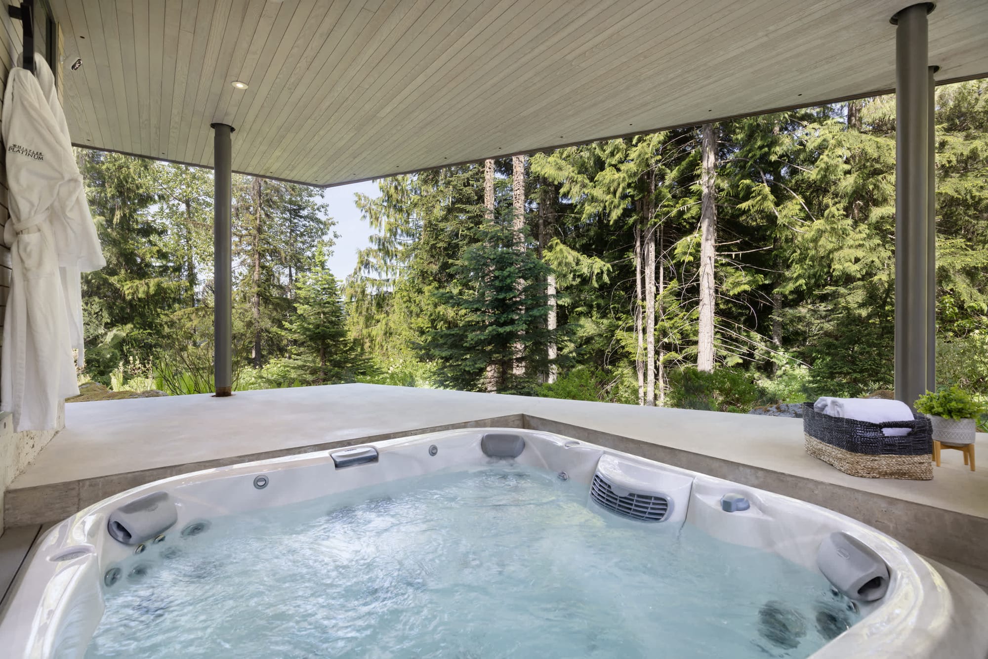 Outdoor hot tub with forest view.