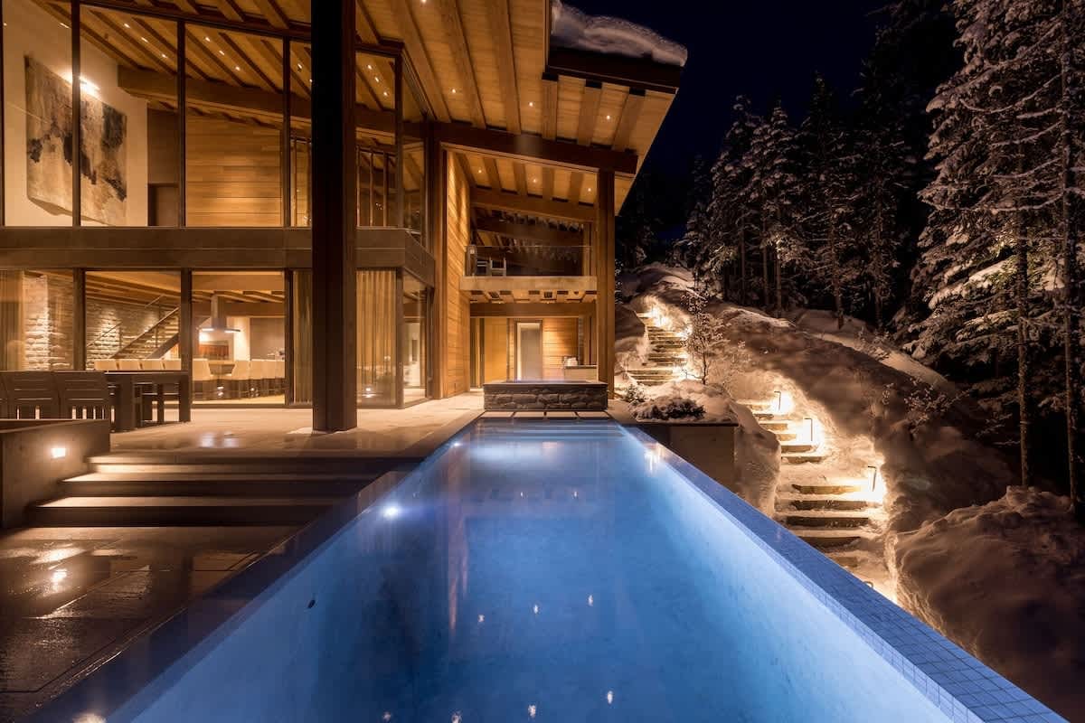 Luxurious snowy chalet with pool.