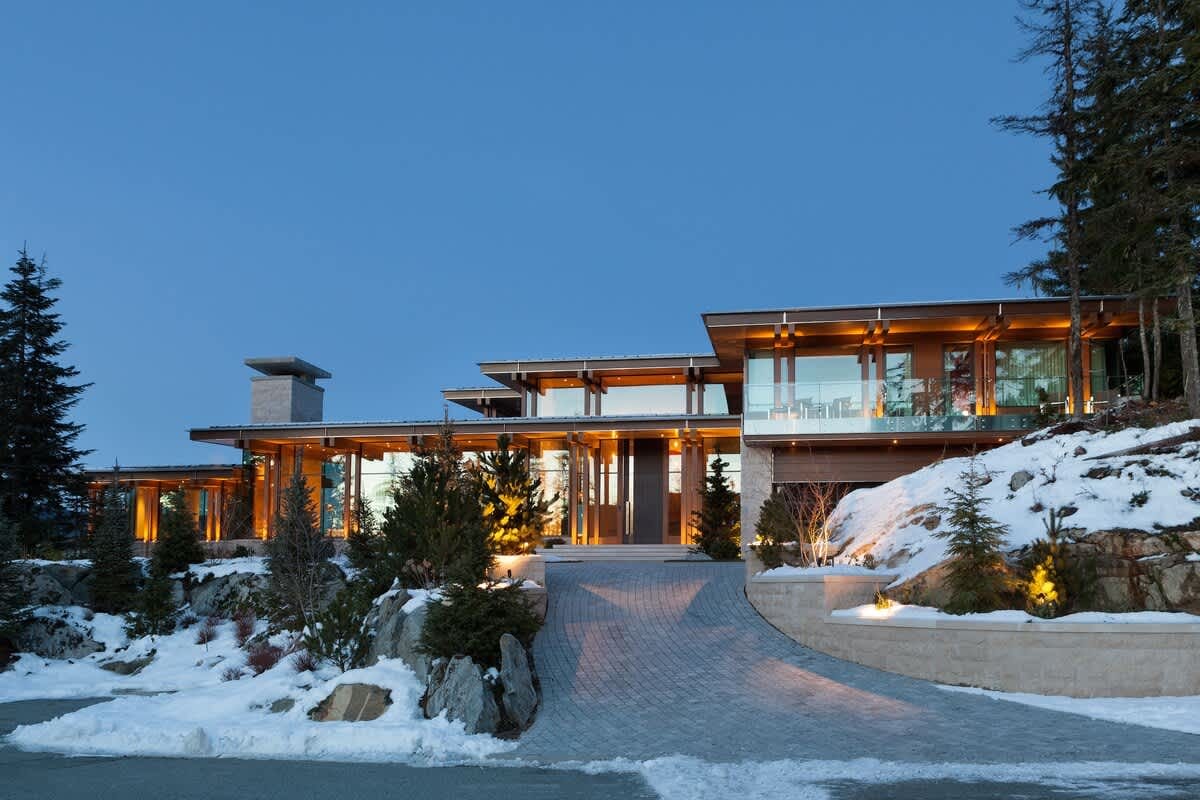 Modern house with snow-covered landscape.