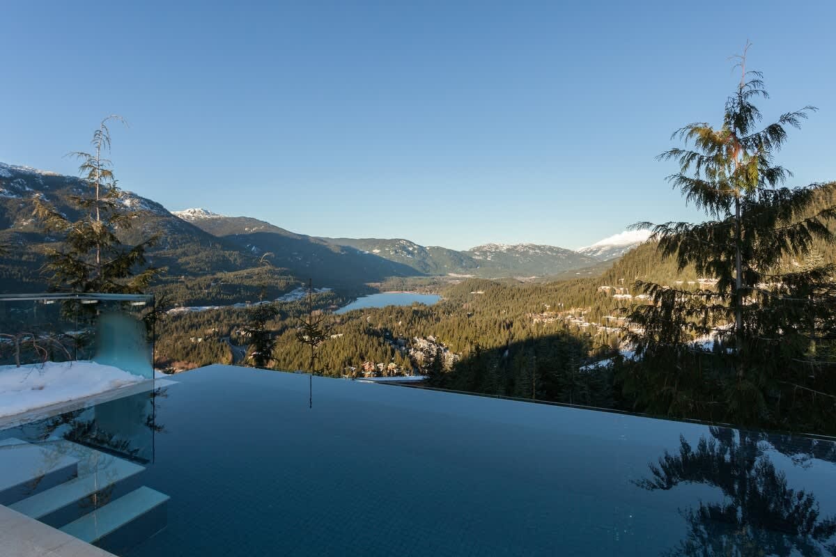 Infinity pool overlooking mountainous landscape.