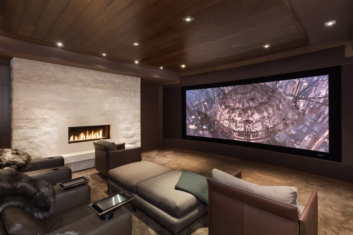 Luxurious home theater with fireplace.