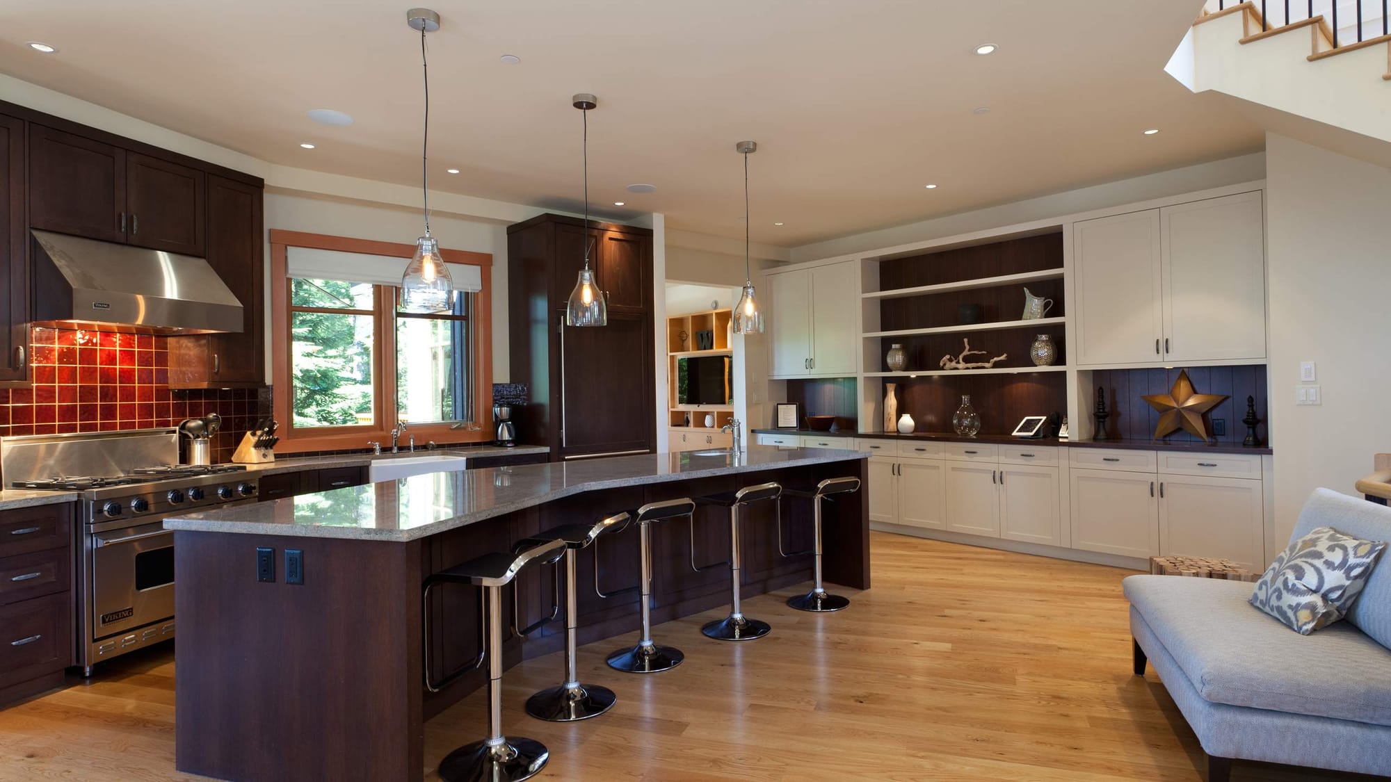 Modern kitchen with island and stools.
