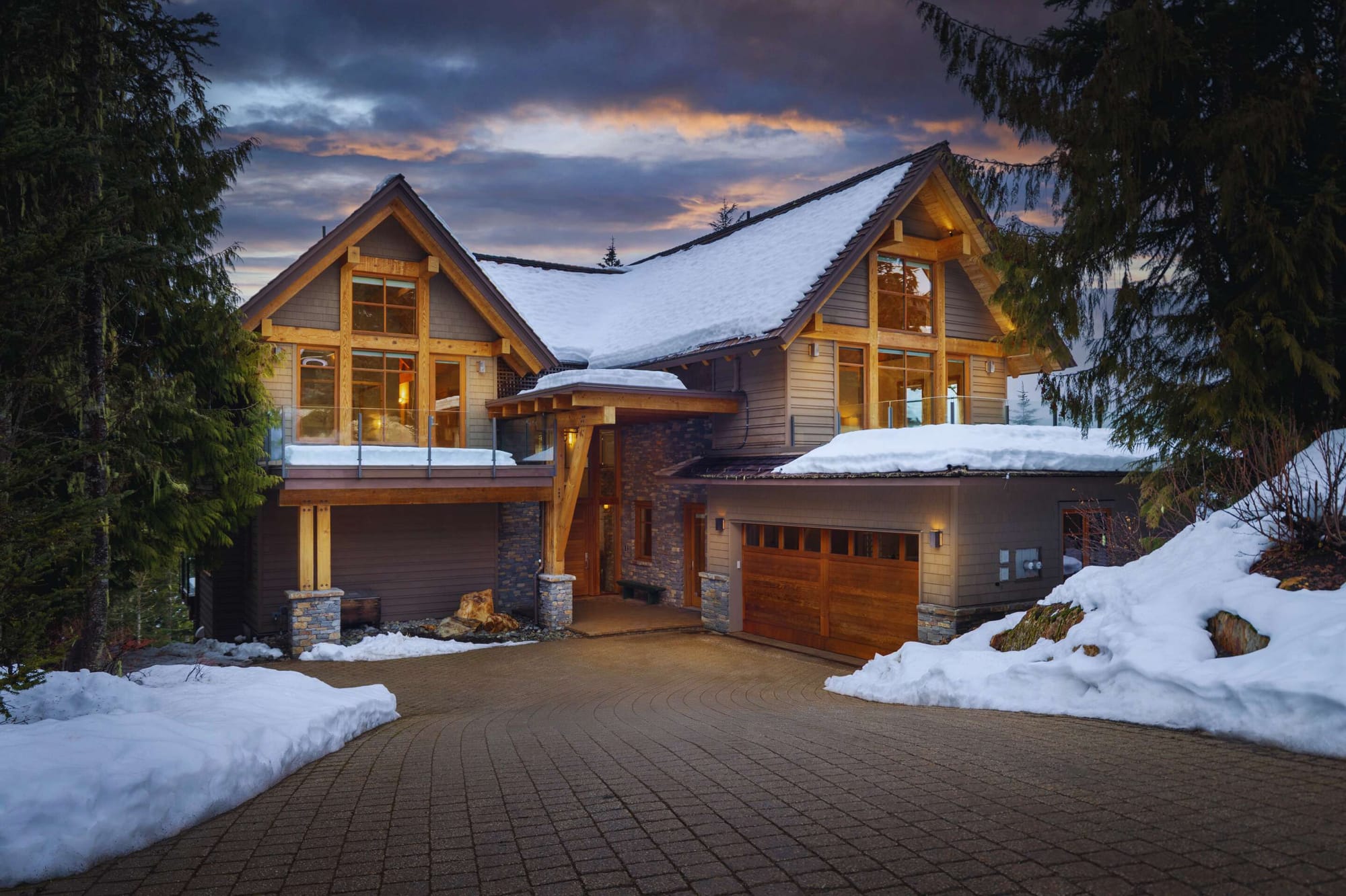 Snow-covered house with large windows.