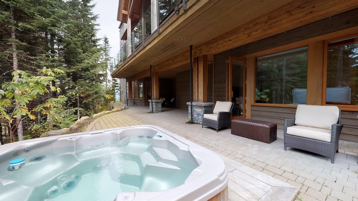 Patio with hot tub and chairs.