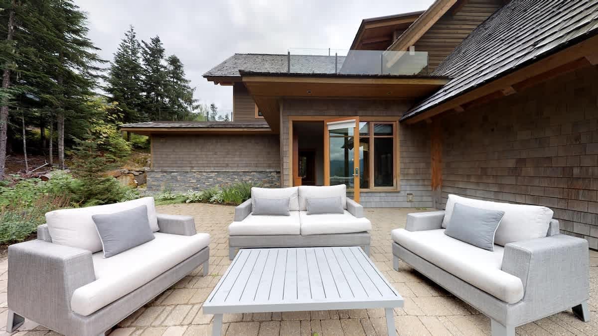 Outdoor patio with white furniture.