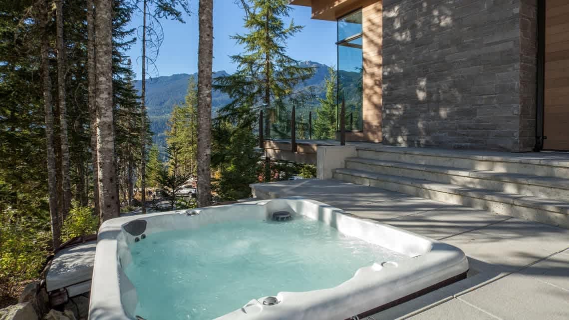 Outdoor hot tub with scenic view.