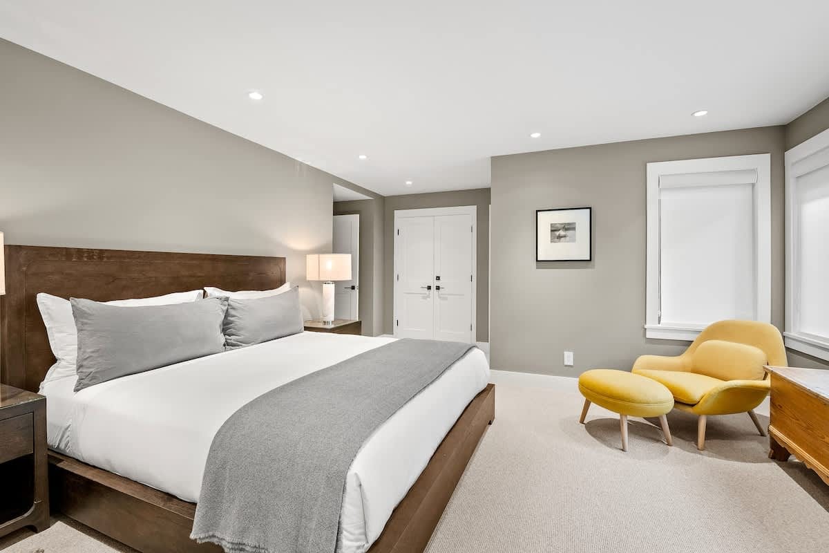 Modern bedroom with yellow chair.