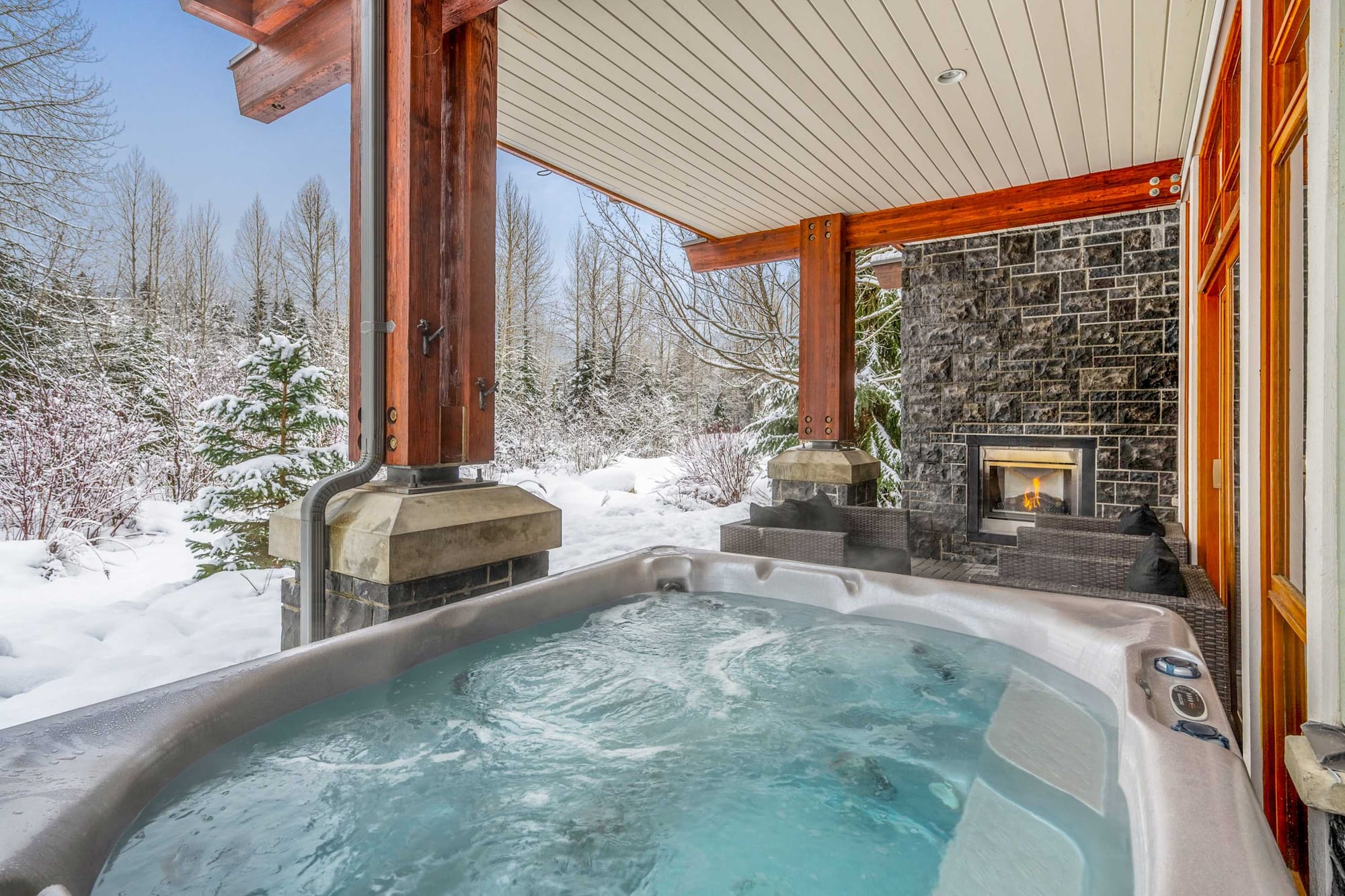Outdoor hot tub, snow, fireplace.