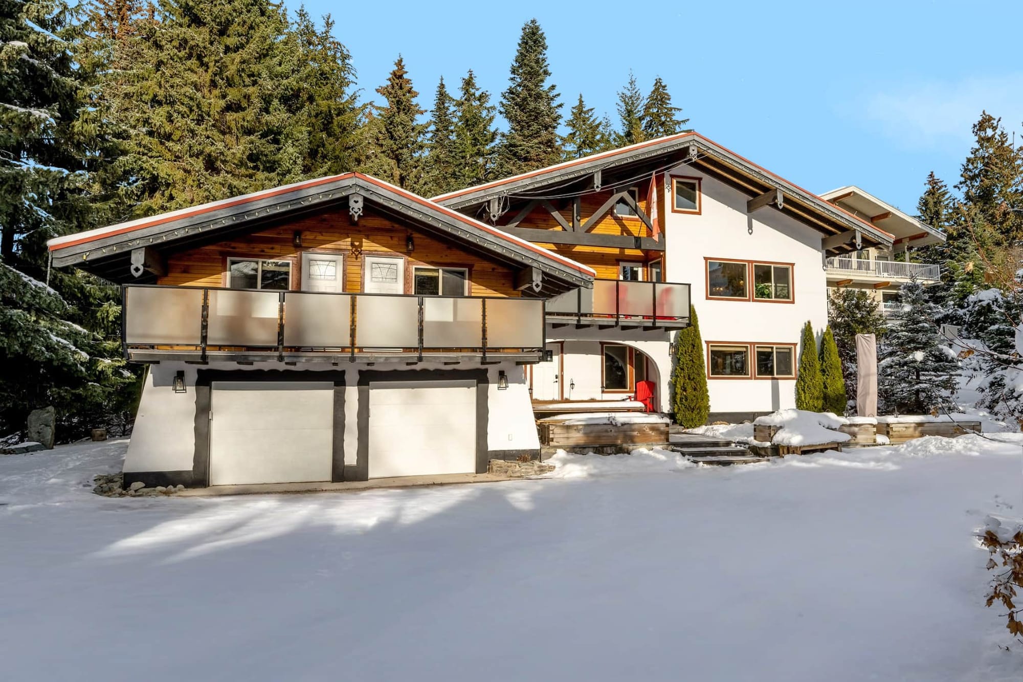 Chalet-style house in snowy landscape.