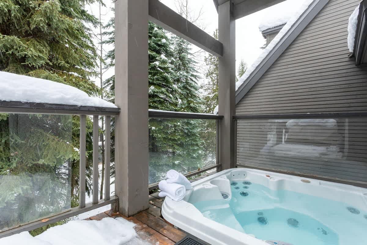 Snowy balcony with hot tub.
