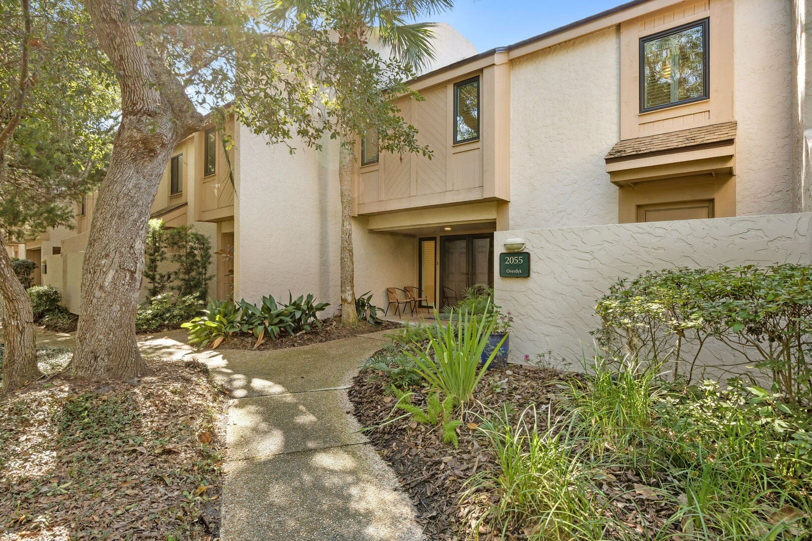 Townhouse entrance with surrounding greenery.