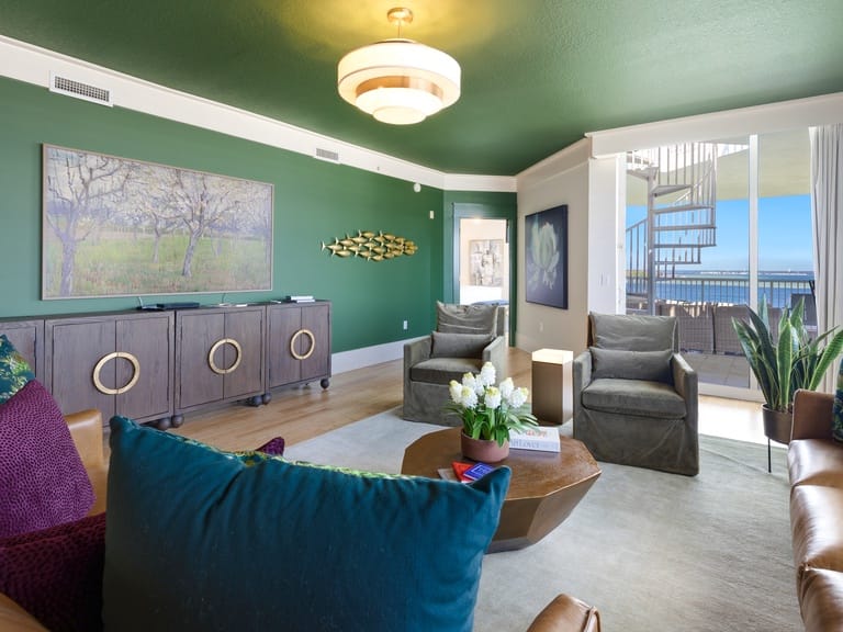 Modern living room with green accents.
