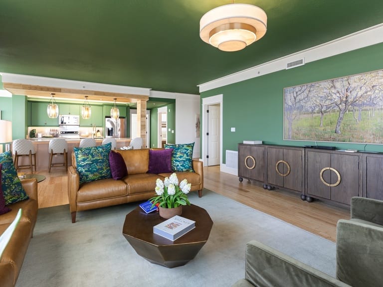 Modern living room with green walls.