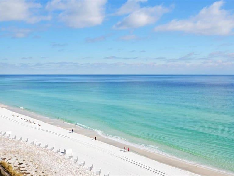 White sandy beach, clear turquoise water.